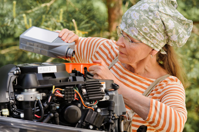 Woman Performing Outboard Motor Oil Change